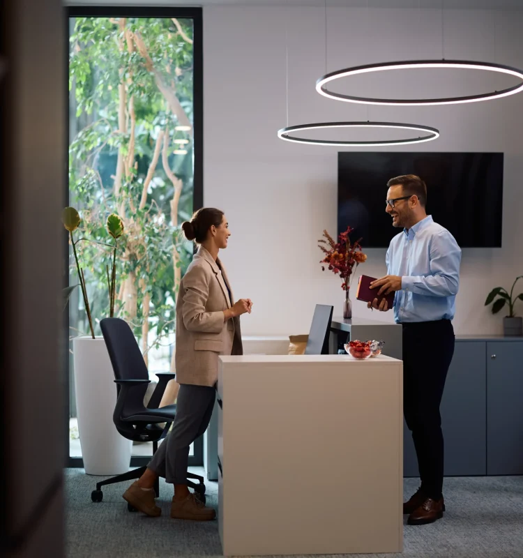 happy-business-colleagues-talking-while-working-in-2024-12-13-18-18-31-utc